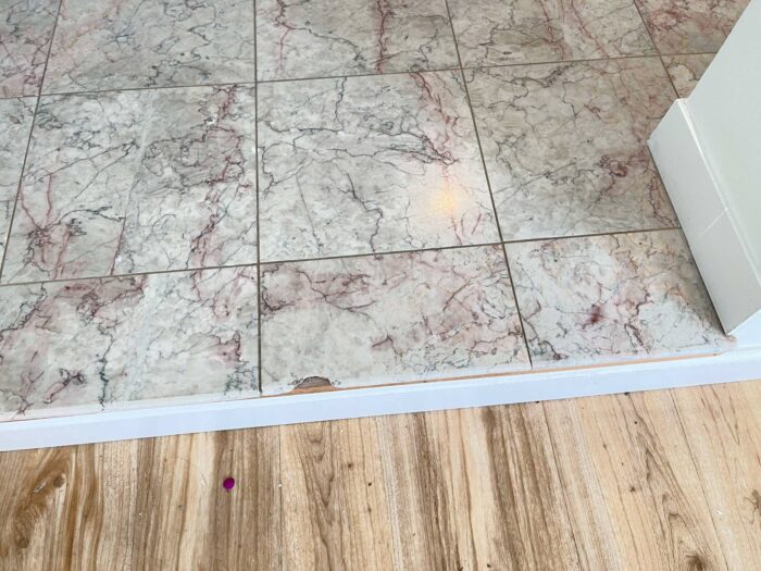 Working on the tiles in a bathroom near Menlo Park. Replacing a chipped edge. 